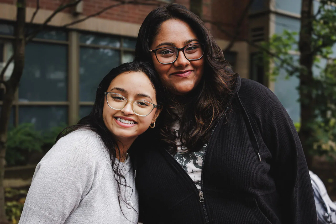 Two Circle K members outside on campus