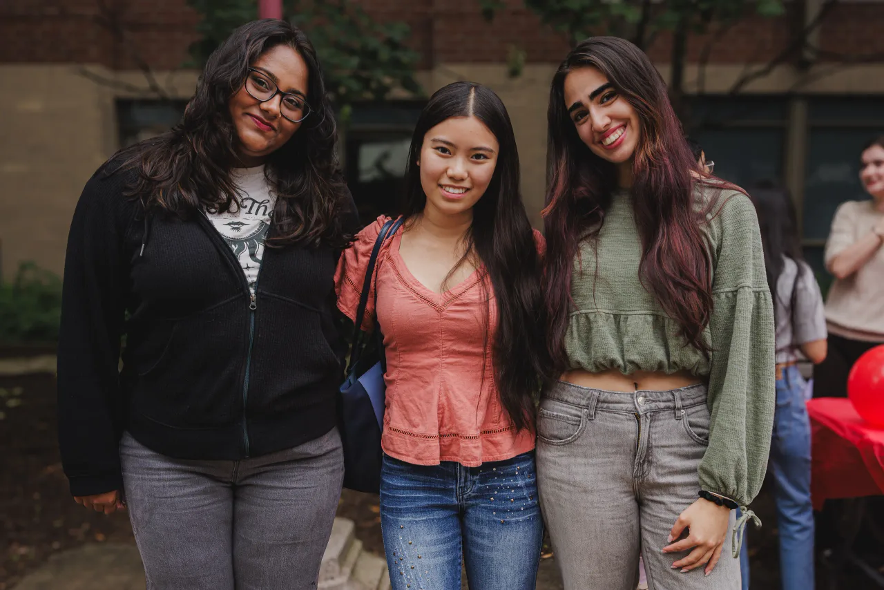 Three Circle K members standing together outside at the fall club fair